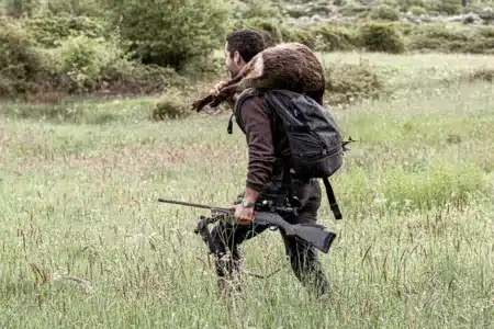 Un cazador con un corzo.